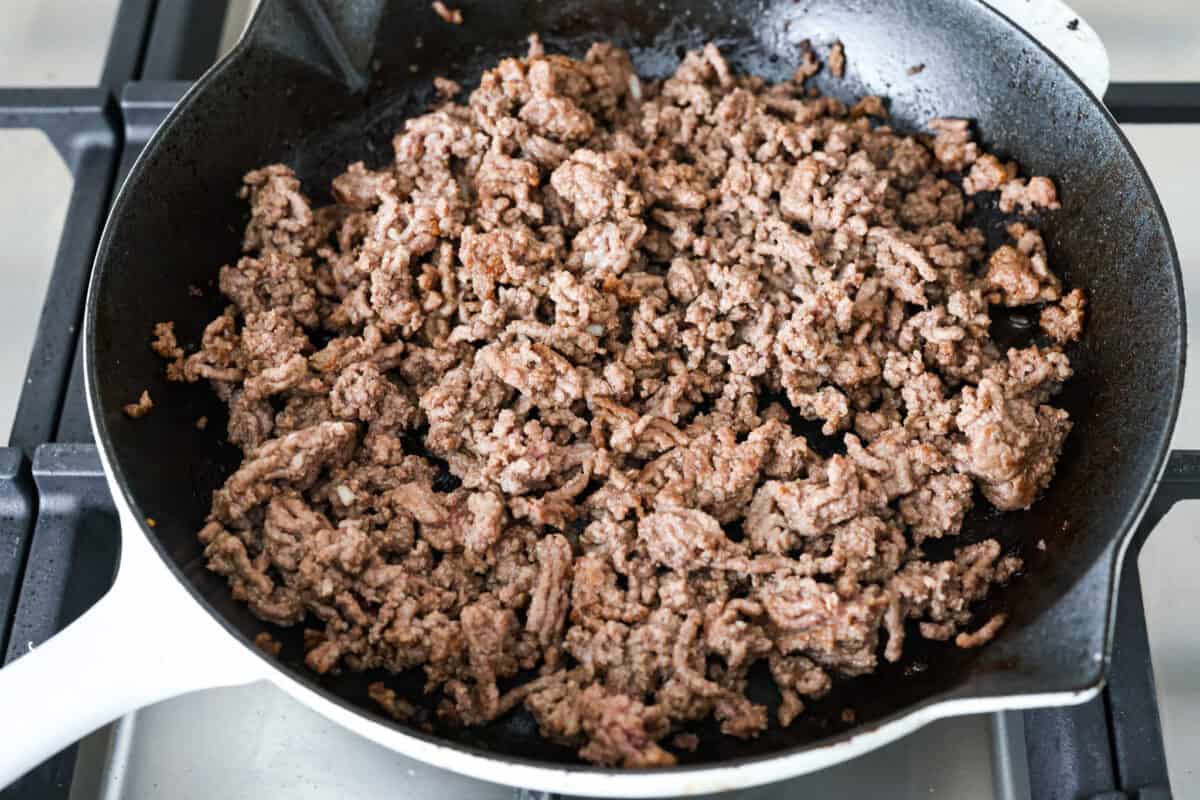 Beef cooking in a skillet. 