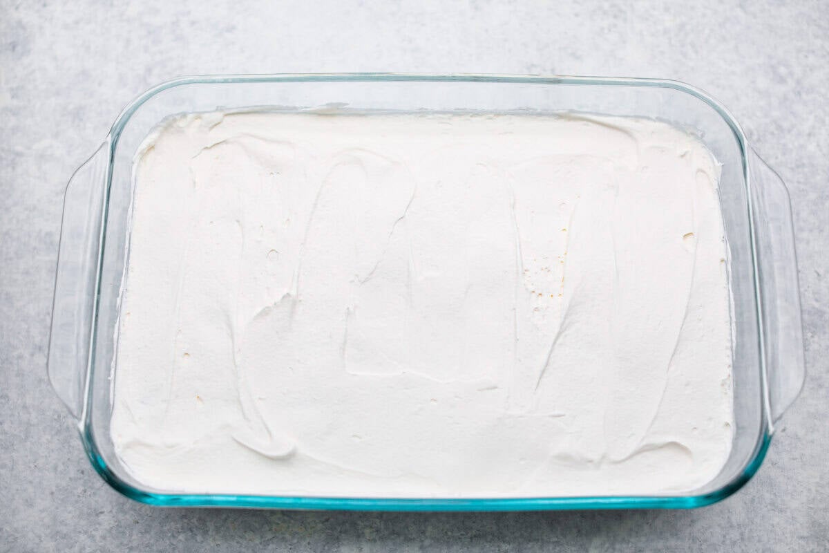 Whipped topping layer added to the top of the apple pie filling.