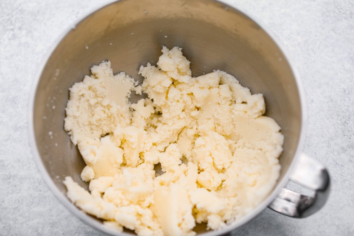 Butter and sugar being creamed together in a stand mixer. 