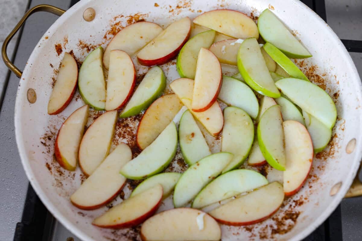 Apple slices in the skillet cooking.