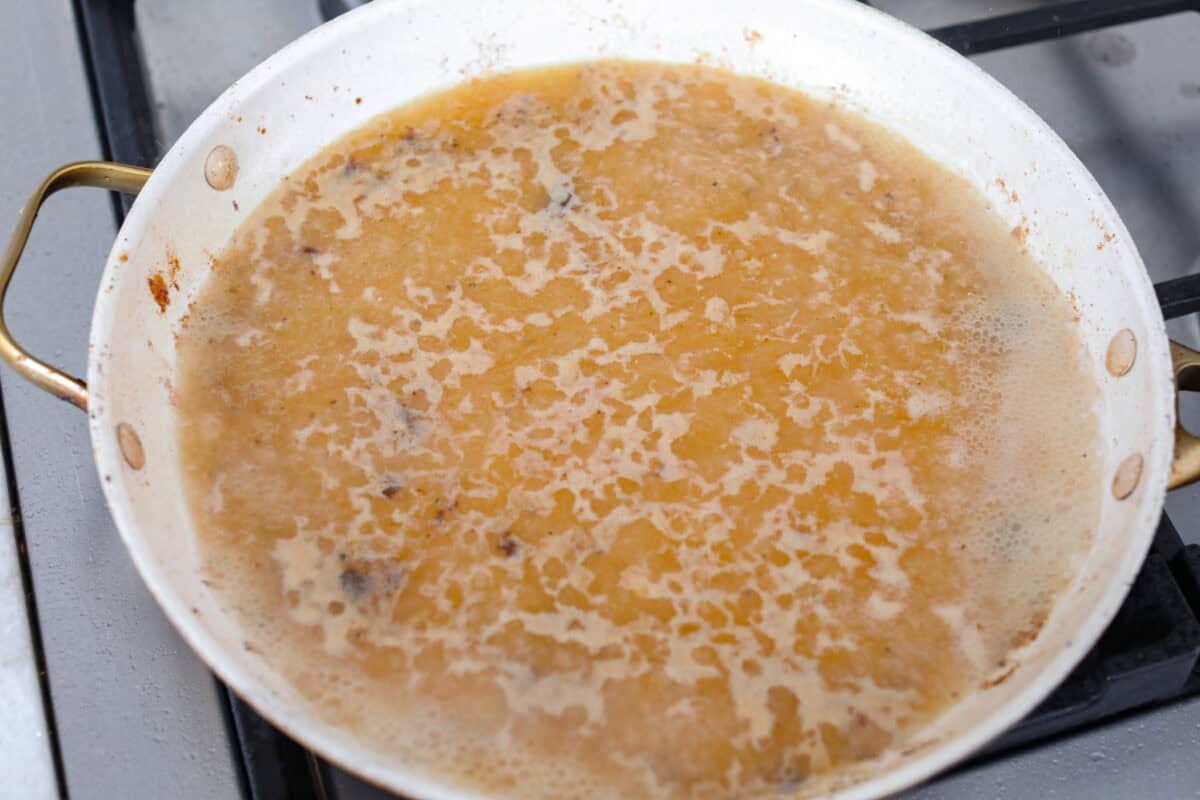 Deglazing the pan with the apple cider, chicken broth and dijon mustard. 