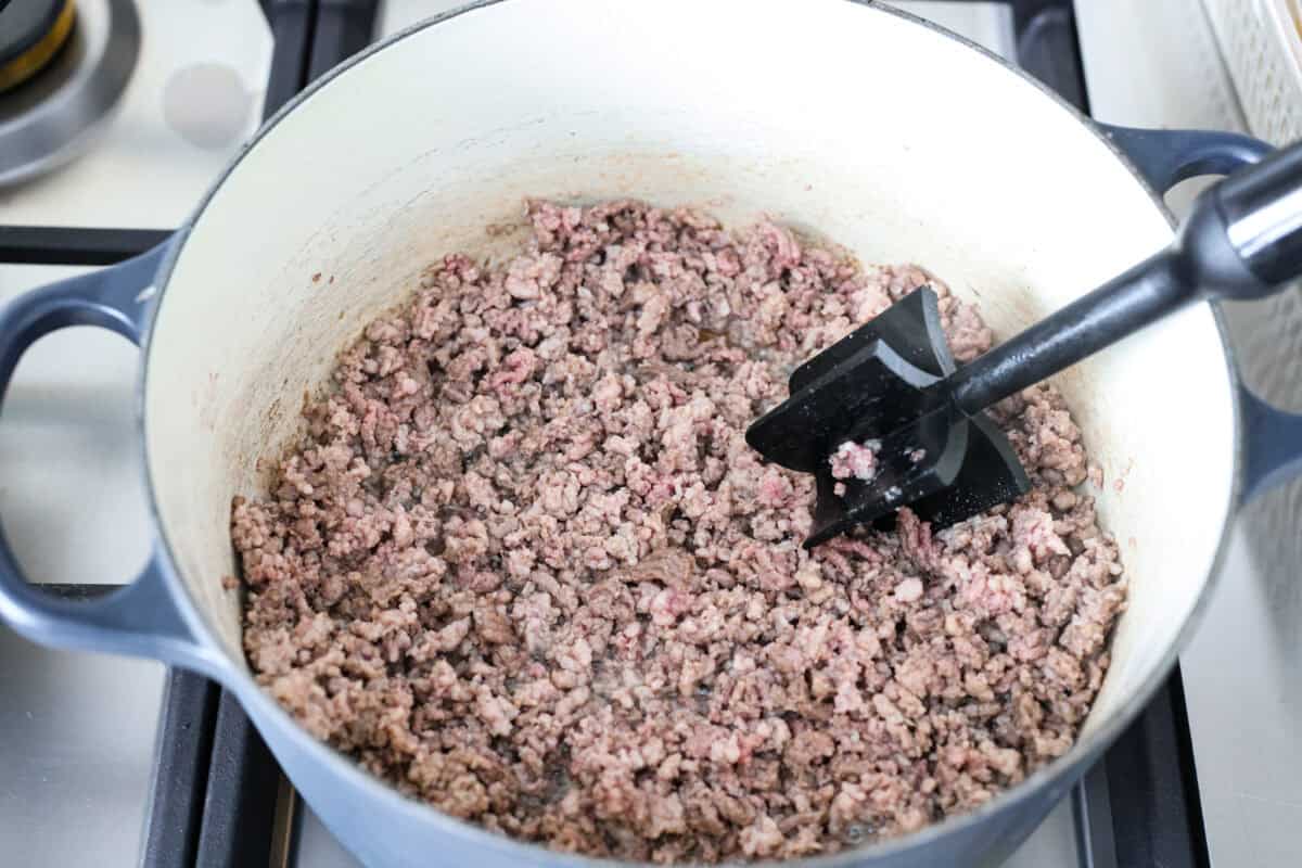 Ground beef and pork cooking in a pot.