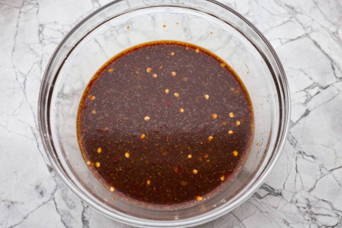 Sauce ingredients whisked together in a glass bowl. 