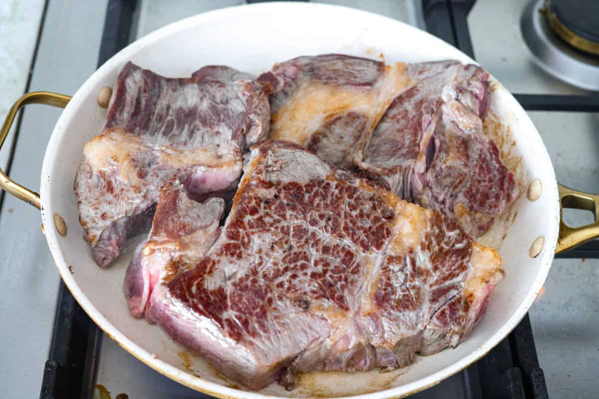 Browning beef in a hot skillet.