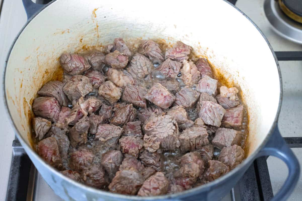 Do you like your chili with beans or without? This authentic Texas chili keeps it classic. Just bold, tender chuck roast, without beans. It has a rich, smoky flavor in every bite. Browning the beef at the bottom of a dutch oven on the stove top.