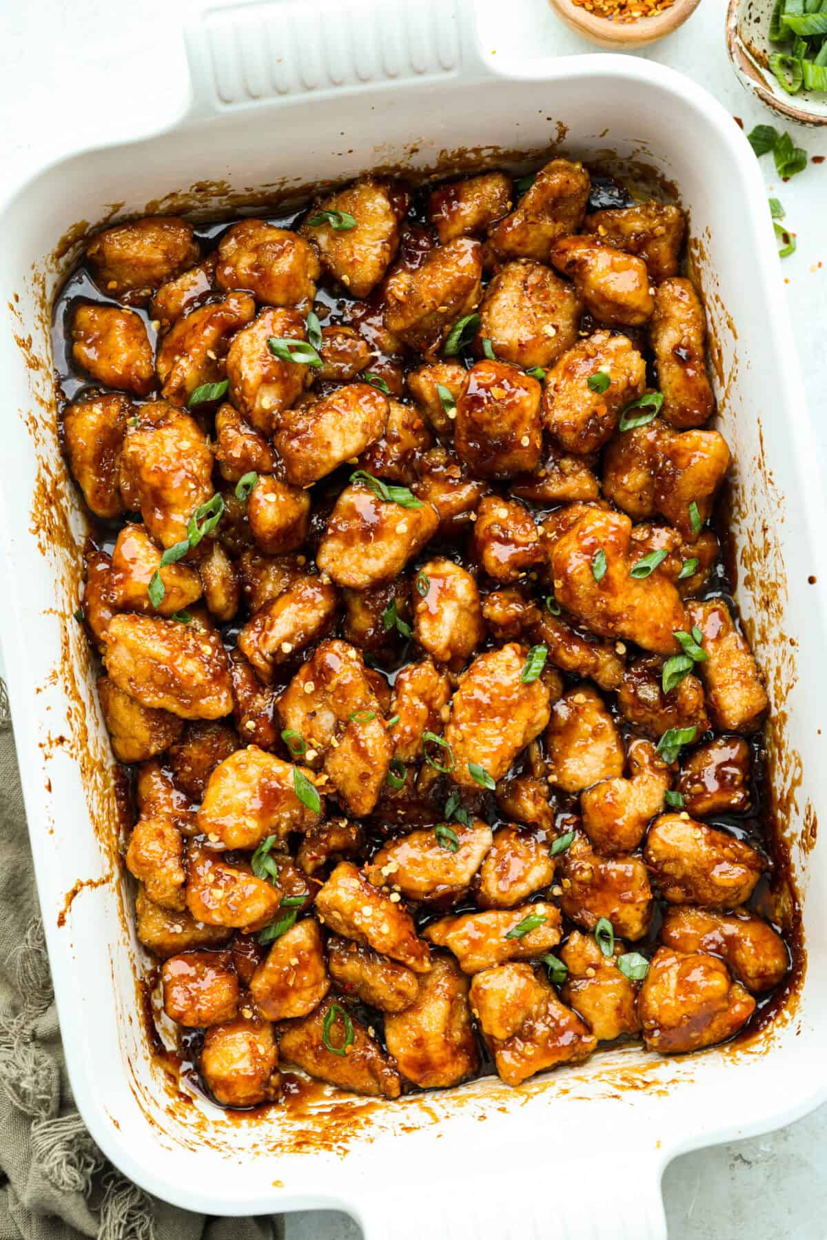 Overhead shot of baked General Tso's chicken in a baking dish. 