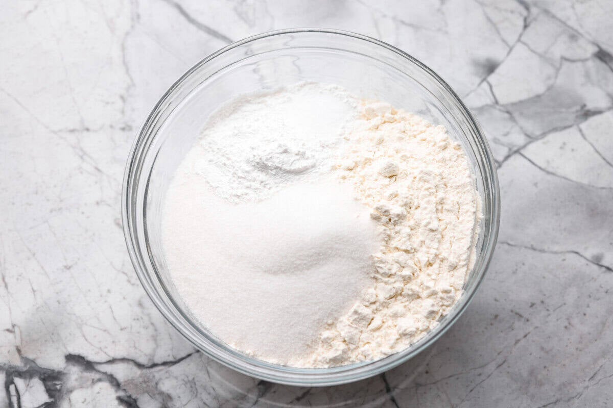 There’s nothing like my homemade Belgian waffles! They're crisp on the outside, soft and fluffy inside, with deep pockets for all the syrup and butter. The secret is whipping the egg whites for that light, airy texture! Dry ingredients added to a bowl.