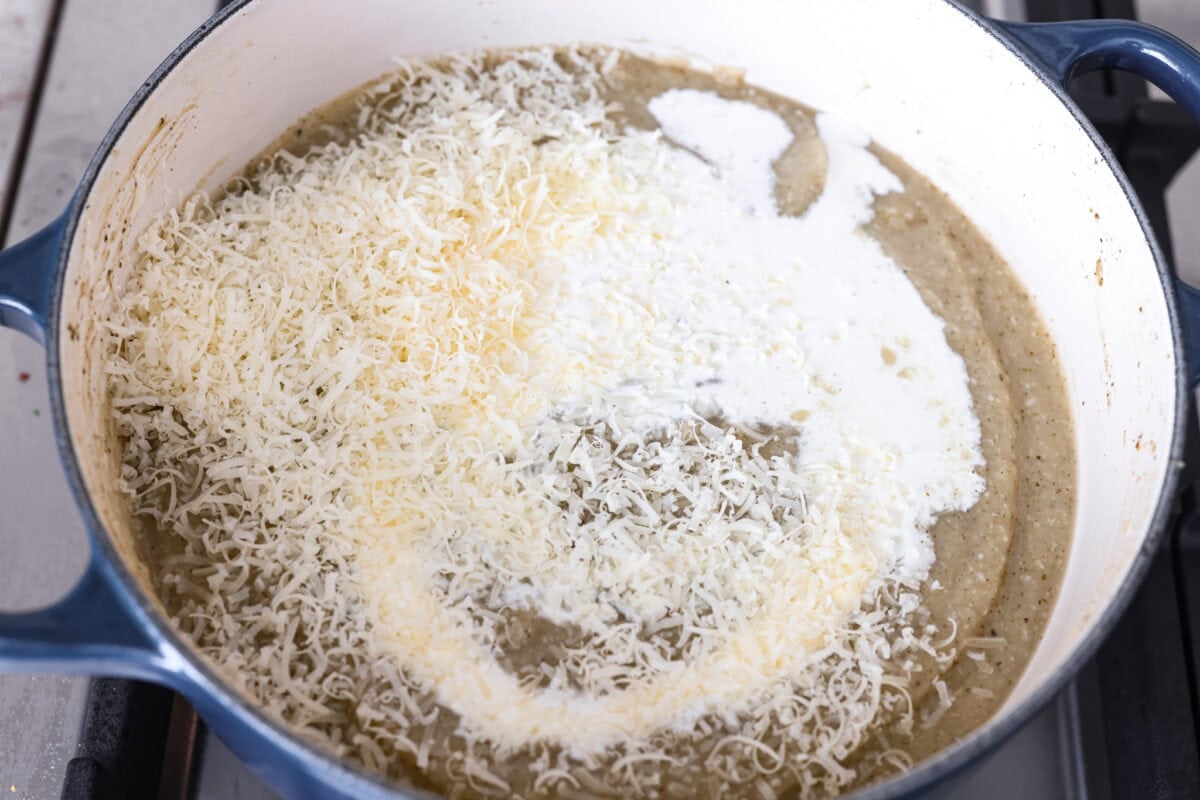 Creamy roasted garlic soup is comfort food with a side of obsession. Combining roasted garlic, tender potatoes, and nutty Parmesan into a cozy soup is absolute perfection. Just make sure you serve it to anyone within hugging distance. Cream and cheese added to the blended up soup.