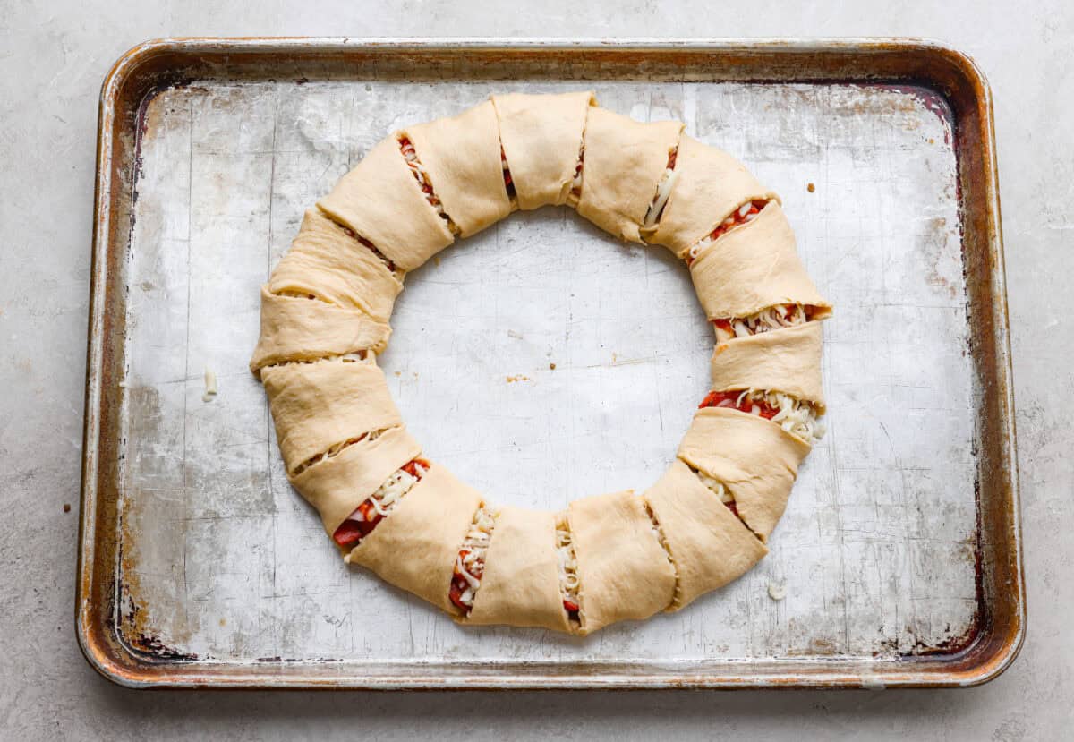Each sunburst point of crescent dough folded over the toppings and cheese to create the pizza ring.