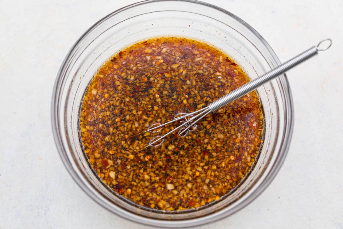 All of the ingredients of the sauce added to a bowl and whisked together.