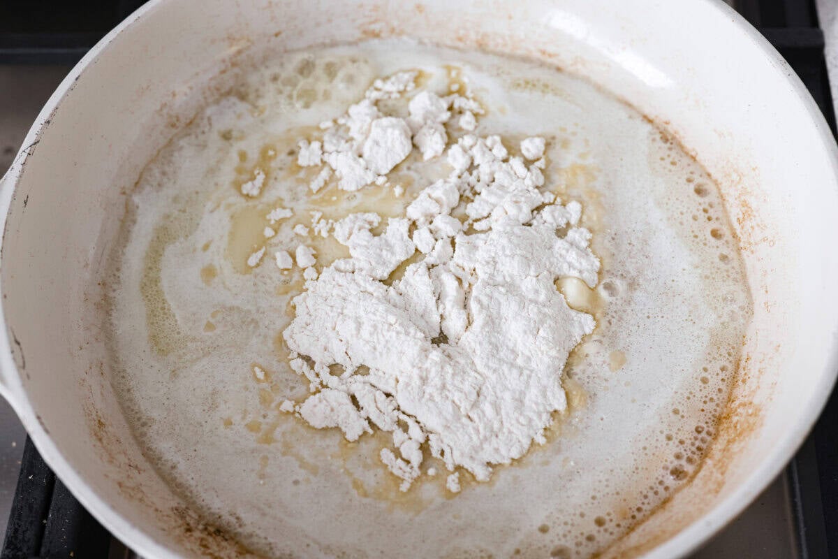 Making a roux with butter and flour added to a pan with pan drippings from cooking meat.