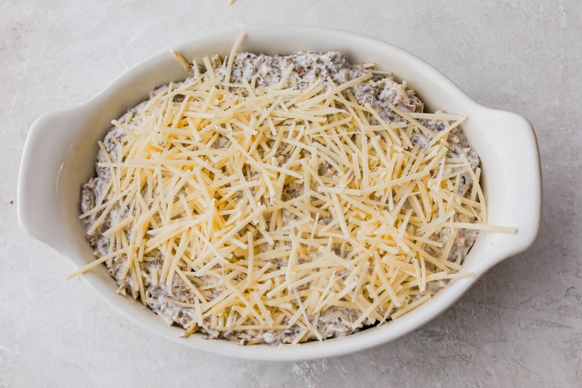 Dip ingredients layered in a baking dish.