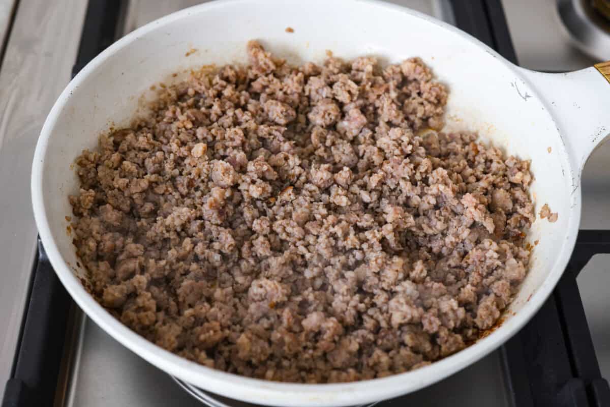 Sausage cooking in a skillet.