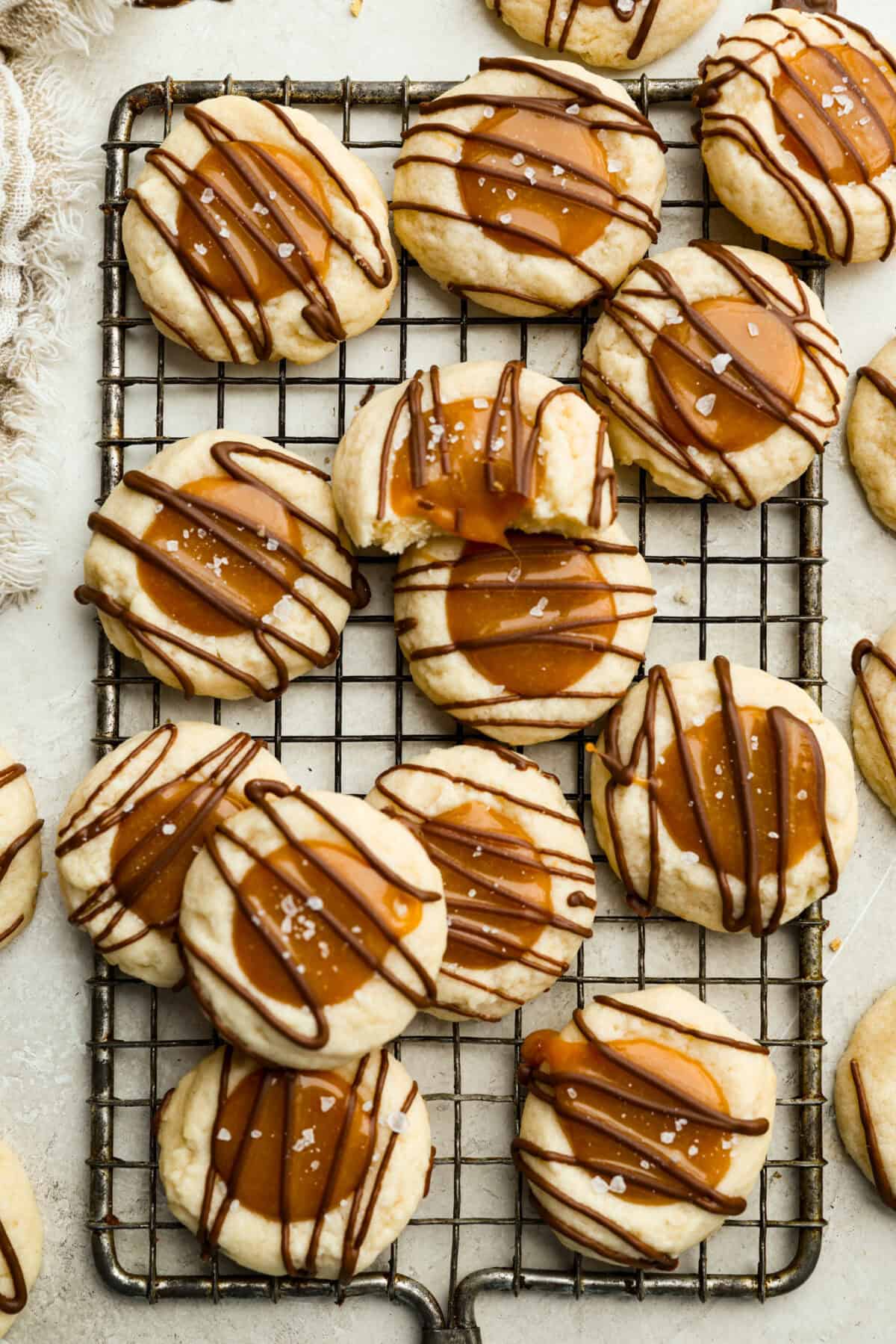 Overhead shot of Twix thumbprint cookies on a cooling rack.