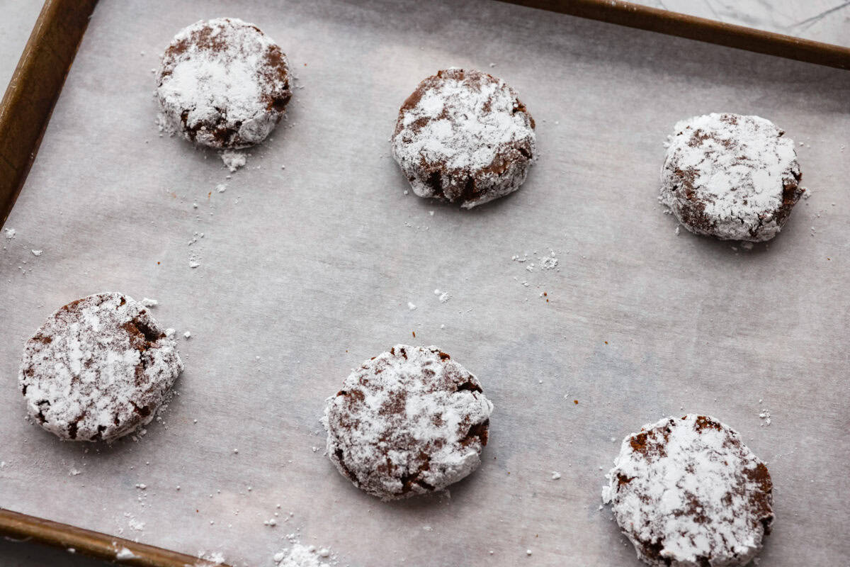 Sugared cookie dough balls on a cookie sheet ready to be baked.