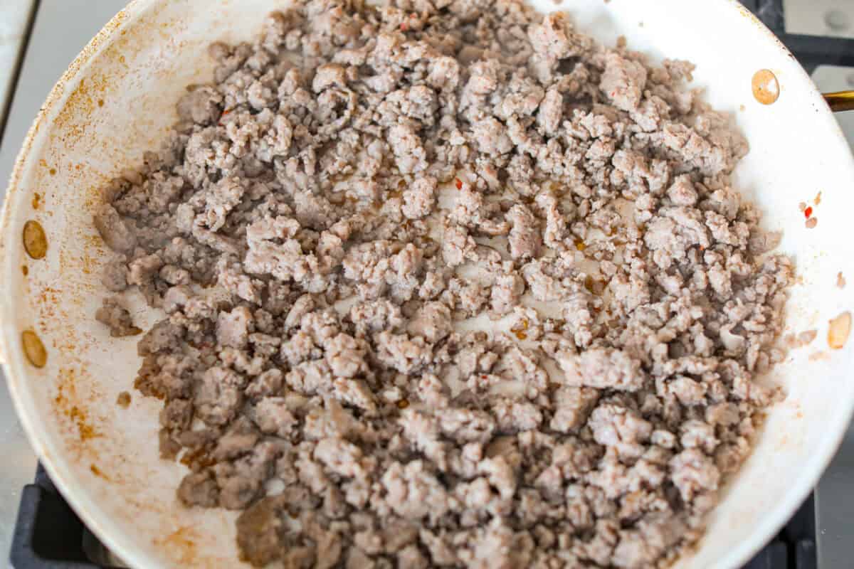 Sausage cooking in a skillet.