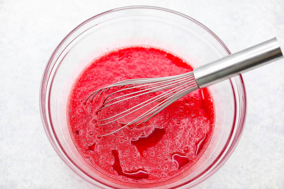 Raspberry Jello being whisked together.