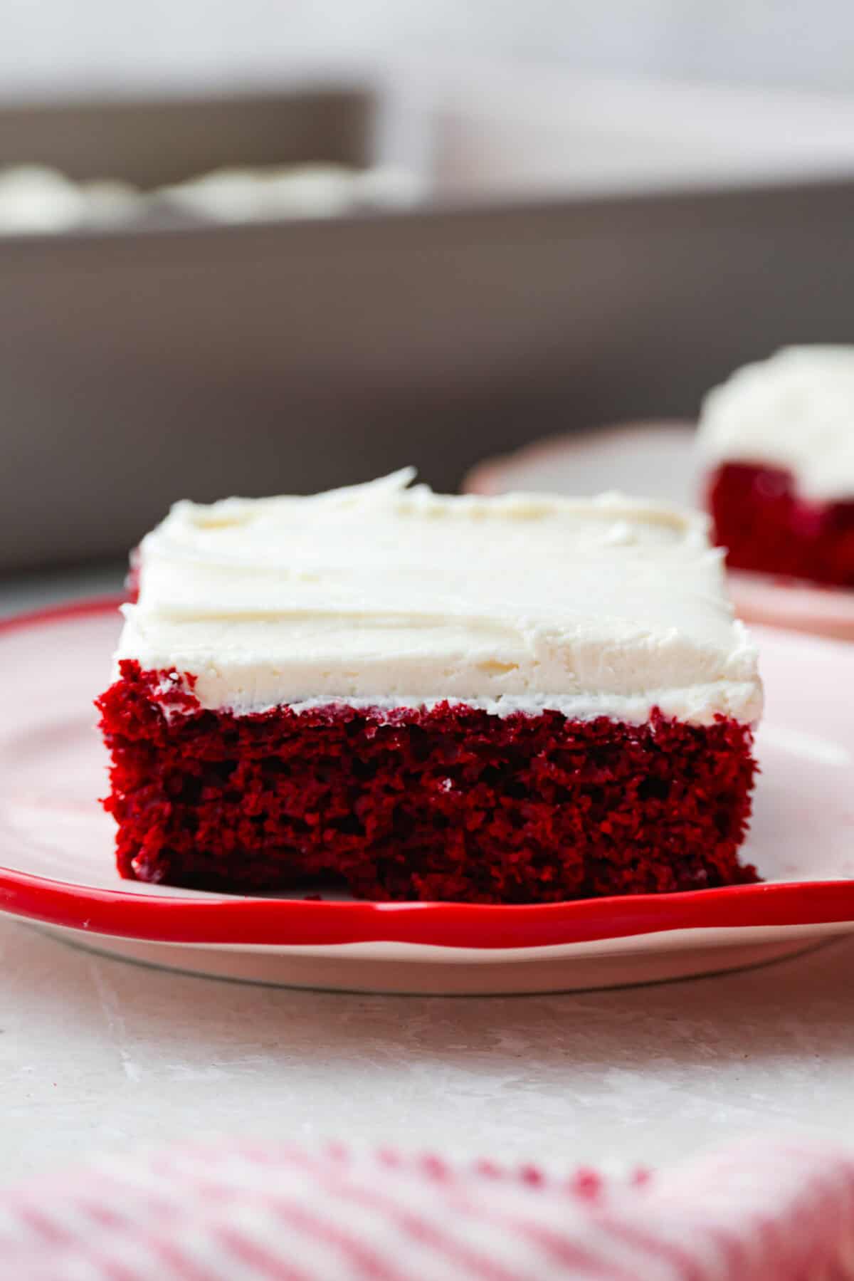 This 2-ingredient red velvet cake is almost too easy to believe! With just a cake mix and a can of soda, you can make a soft, fluffy cake in minutes. It’s the perfect shortcut dessert for Valentine’s Day or any sweet craving! Slice of 2 ingredient red velvet cake on a plate.