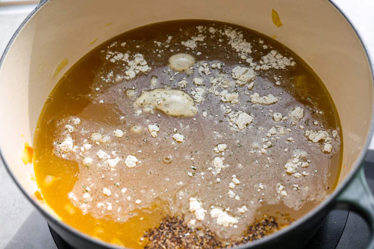 Broth and seasoning added to the pot.