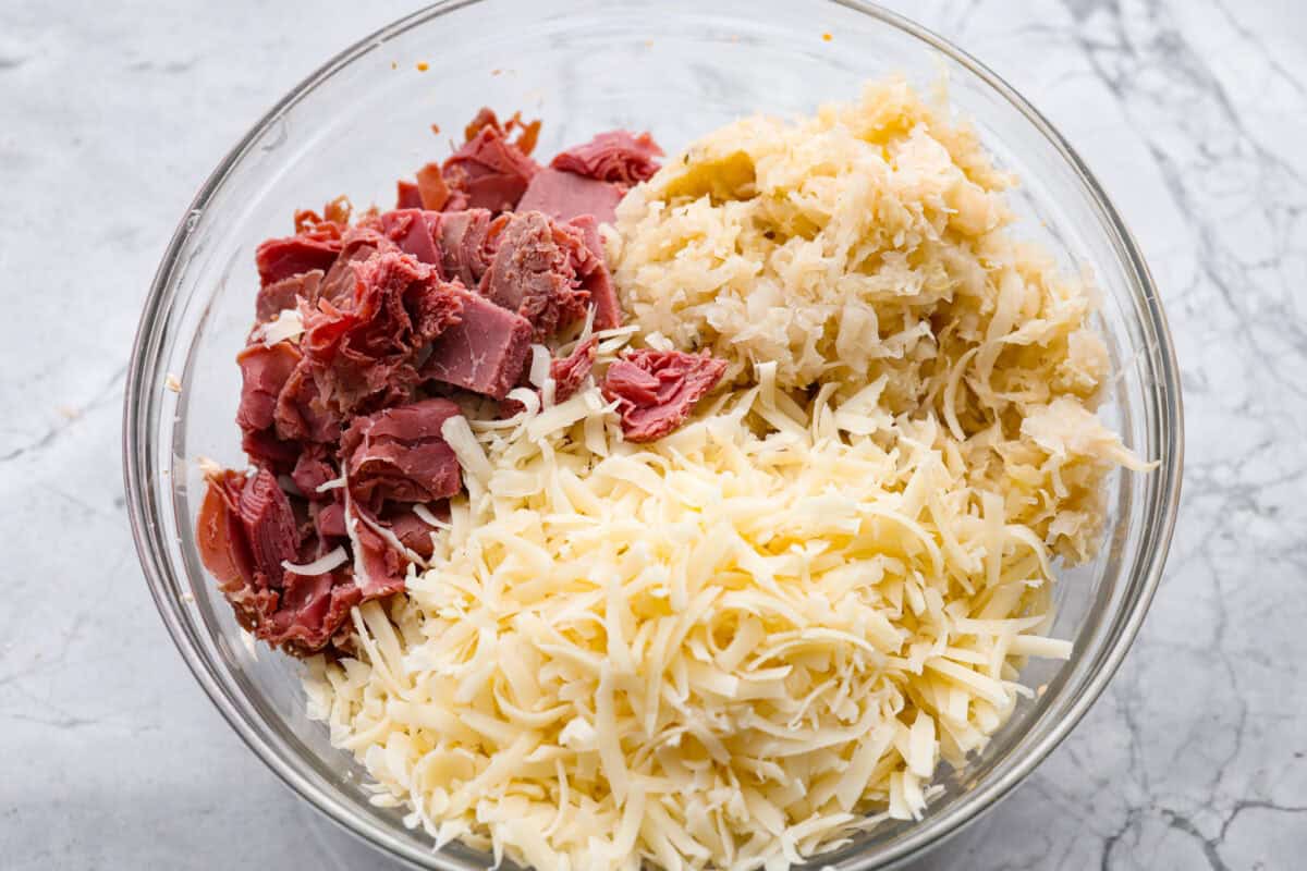 Think of this hot Reuben dip as a love letter to the classic Reuben sandwich. It’s rich, tangy, loaded with corned beef and sauerkraut, and the perfect way to turn St. Patrick’s Day leftovers into something everyone fights over. Sauerkraut, corned been and Swiss cheese added to the mixture.