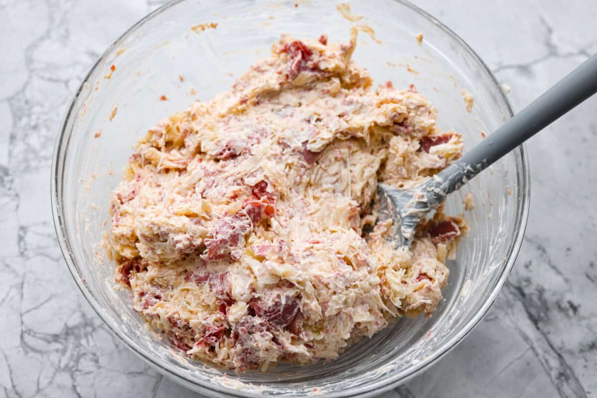 Think of this hot Reuben dip as a love letter to the classic Reuben sandwich. It’s rich, tangy, loaded with corned beef and sauerkraut, and the perfect way to turn St. Patrick’s Day leftovers into something everyone fights over. All of the ingredients combined.