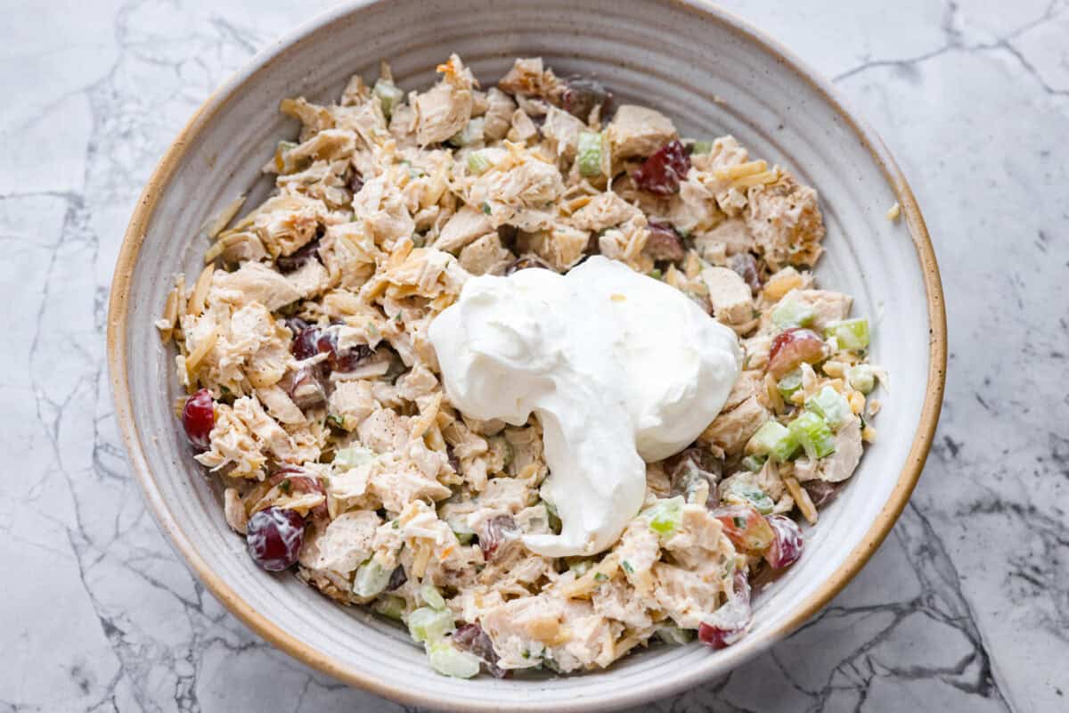 Dollop of the whipped cream added to the chicken salad. 