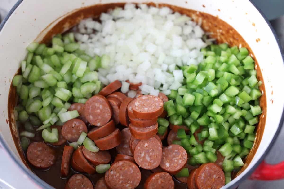 Veggies and sausage added to the roux.
