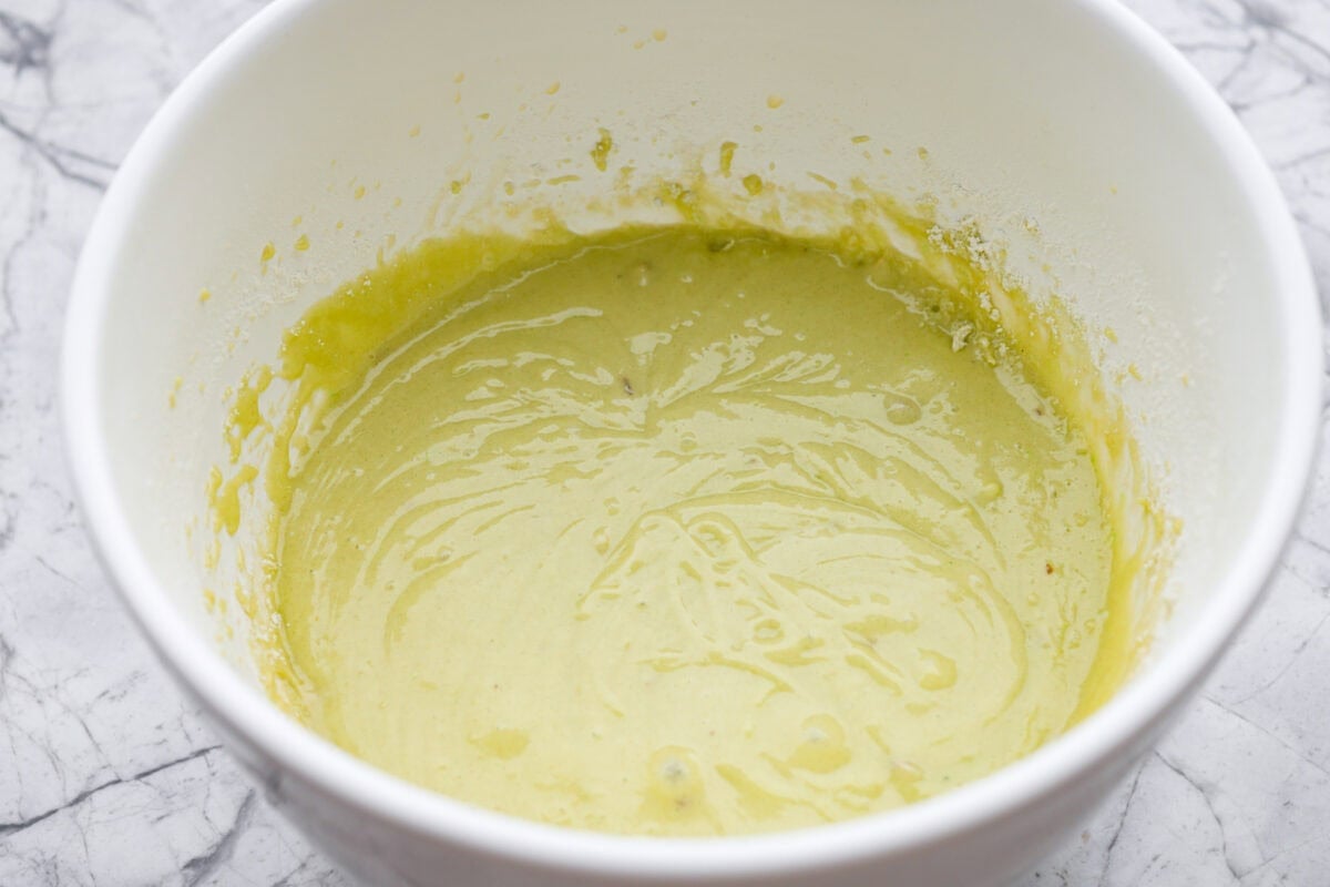 Wet and dry ingredients combined in a mixing bowl. 