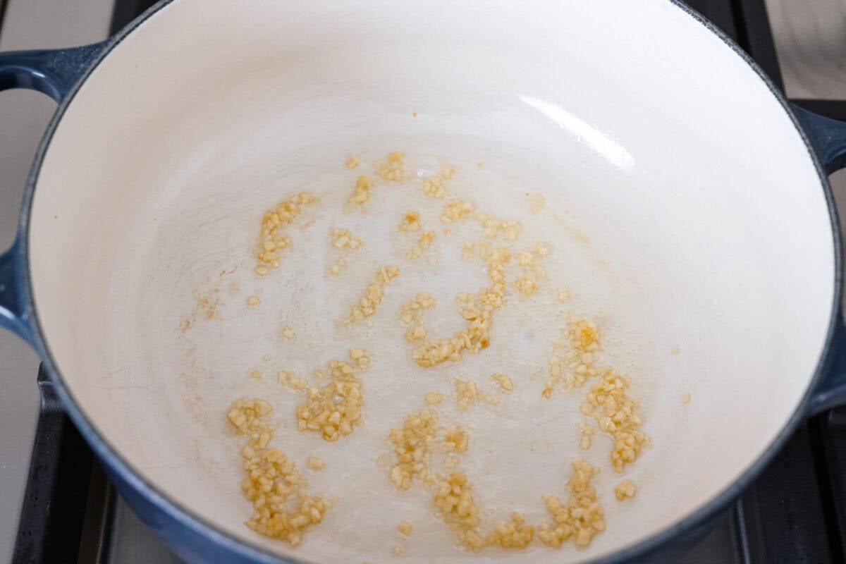 Garlic cooking in a pan with olive oil. 