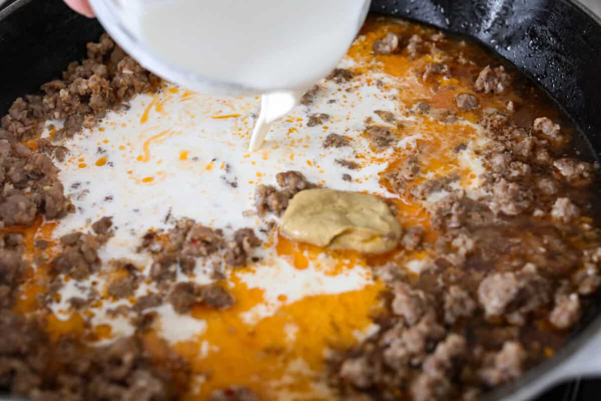 If you love a creamy pasta with big flavor, this creamy sausage spaghetti needs to be on your menu. Smoked Gouda adds depth, the sausage brings a little heat, and fresh basil adds brightness. Simple ingredients, quick to make, and always a hit! Cream and dijon mustard added to the sausage mixture.