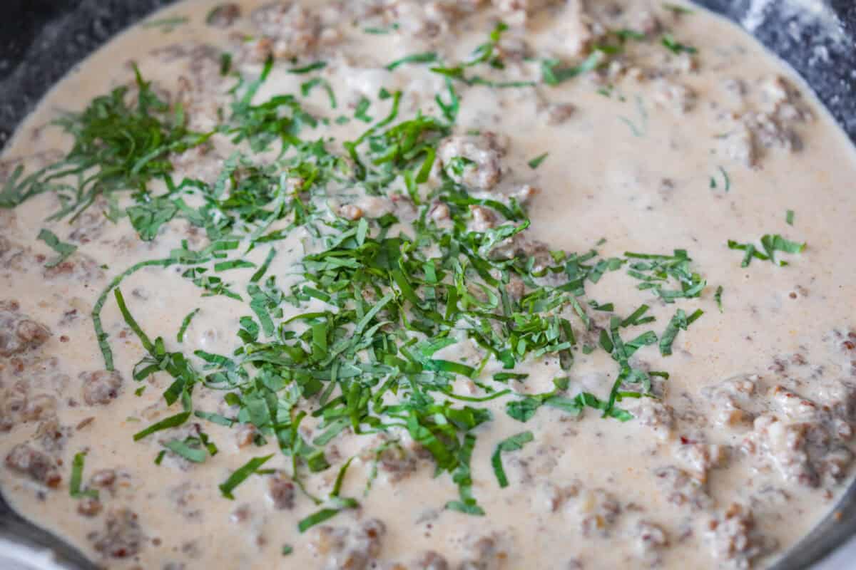 If you love a creamy pasta with big flavor, this creamy sausage spaghetti needs to be on your menu. Smoked Gouda adds depth, the sausage brings a little heat, and fresh basil adds brightness. Simple ingredients, quick to make, and always a hit! Fresh basil and salt and pepper added to the sausage mixture.