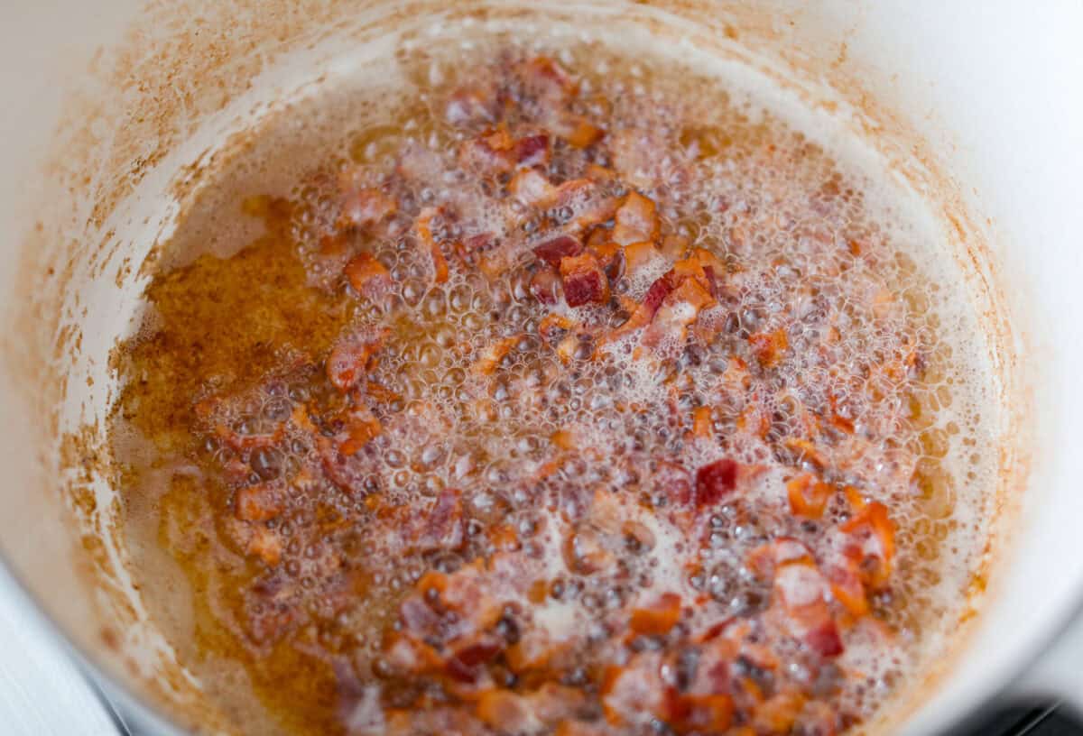 Bacon cooking in a large pot.