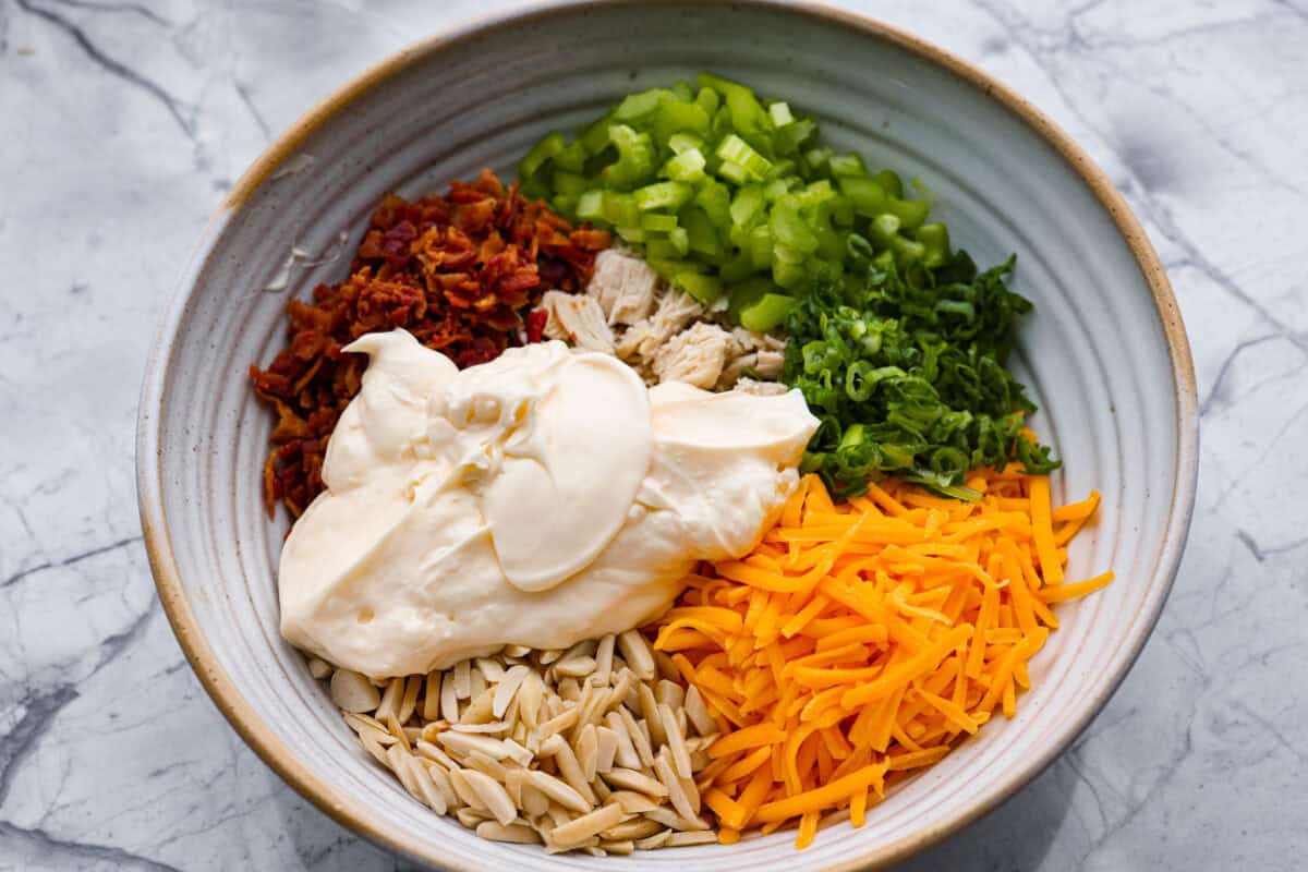 Mayonnaise added to the bowl of ingredients. 