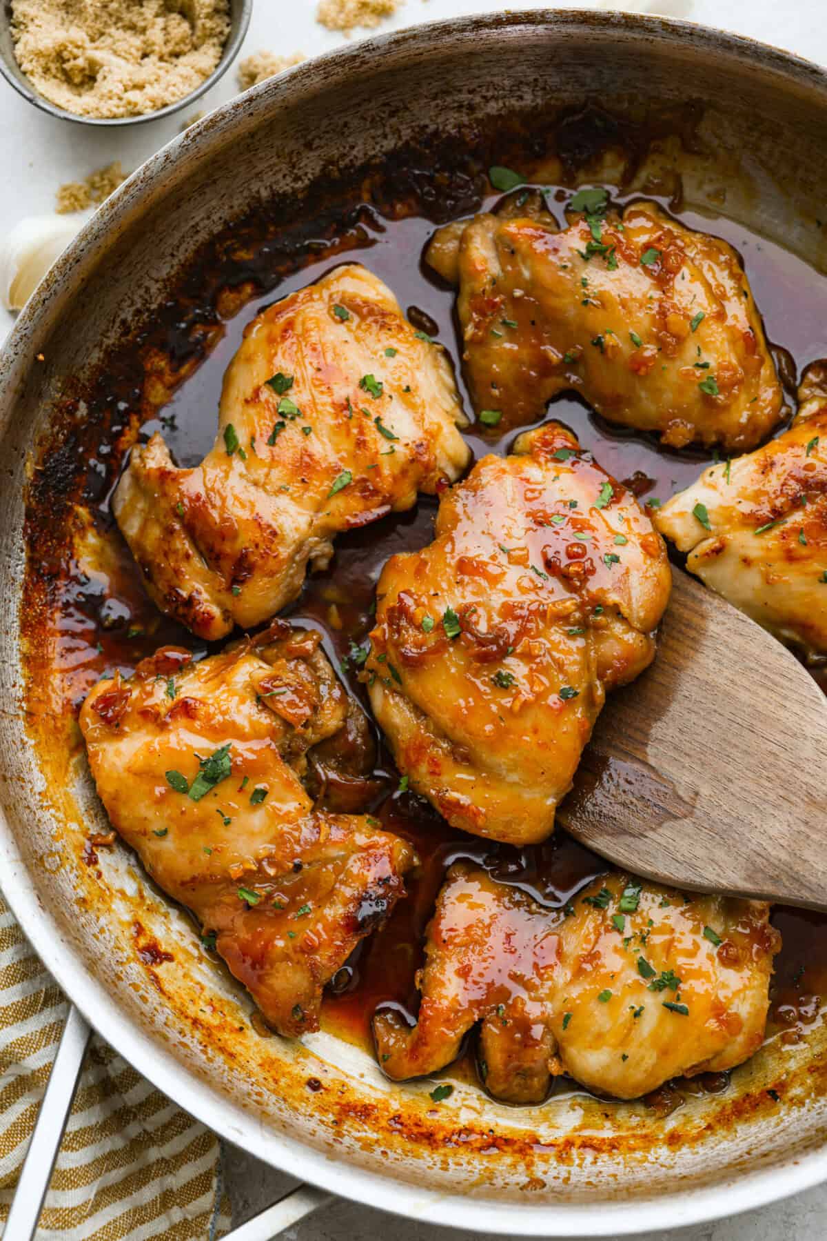 Overhead shot of brown sugar chicken thighs in a skillet.