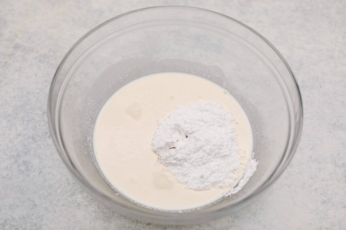 Whipping cream ingredients all added to a bowl. 