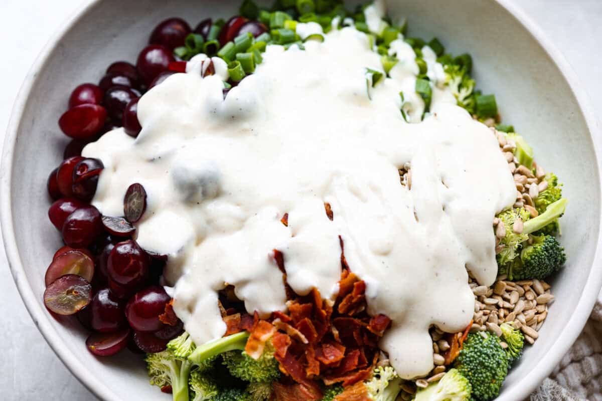 Broccoli grape salad is the crunchy, juicy, smoky combo nobody expects but everyone loves. Sweet grapes, crisp broccoli, smoky bacon, and a tangy lemon dressing come together in just 20 minutes! Dressing added to the top of the salad ingredients.