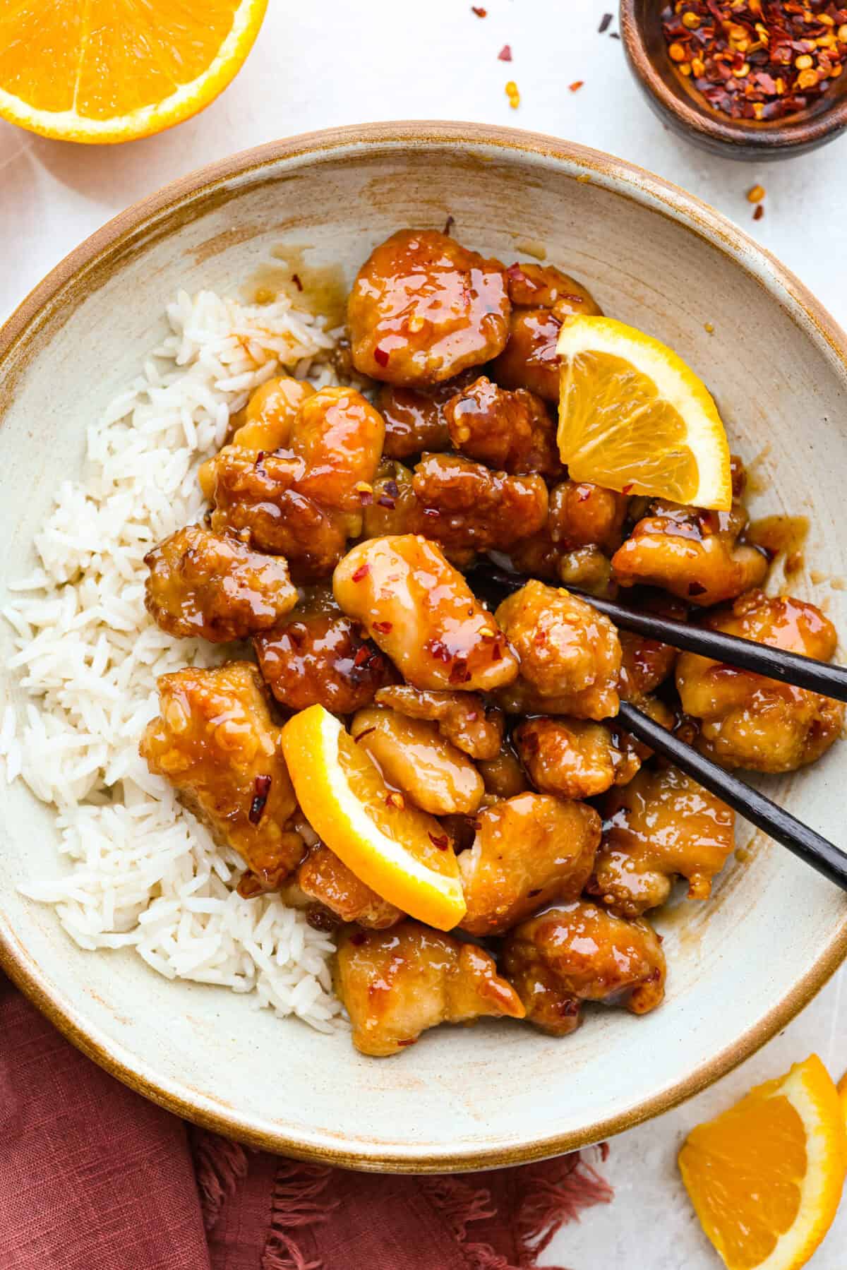 Plated Panda Express Orange chicken on a bed of white rice. 