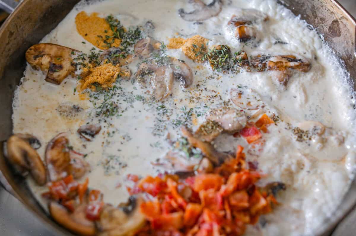 If cozy dinners are your thing, this creamy bacon mushroom thyme chicken needs to happen soon. Between the crispy chicken skin, smoky bacon, and creamy mushroom sauce, every bite tastes rich and savory. Perfect for spooning over mashed potatoes! Sauce ingredients added to the skillet with the mushrooms.