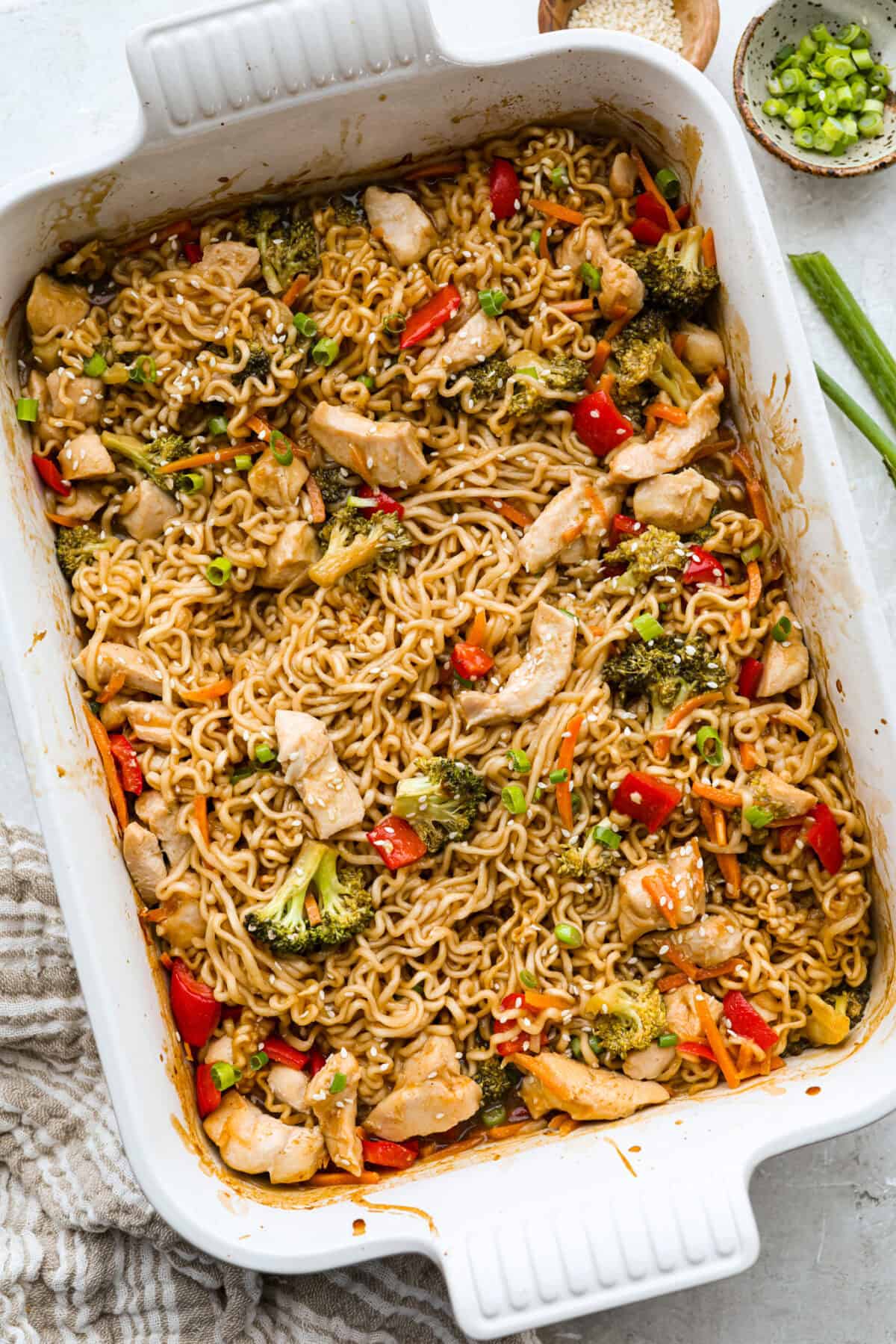 I kept seeing this dump and bake ramen all over my feed and finally had to try it for myself! Turning family favorite ramen into a cozy baked dinner was an immediate hit! It's so good with tender noodles, colorful veggies, and a savory sauce! Dump and bake ramen all cooked in a baking dish.