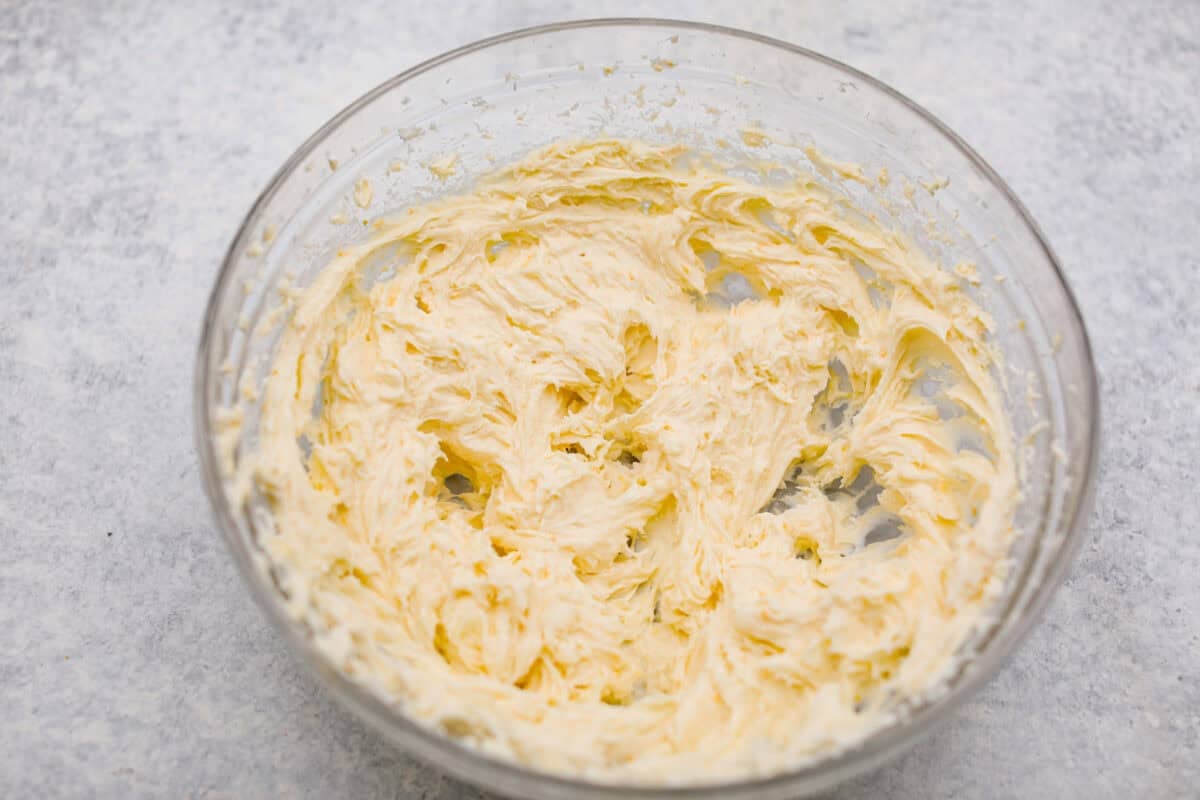 Orange creamsicle lush is sunshine in dessert form! With creamy orange layers, a buttery golden Oreo crust, and bright fresh citrus flavor, this easy no-bake dessert is a fun twist on my popular Lemon Lush that’s perfect for summer. Cream cheese, sugar, and orange zest all mixed together.