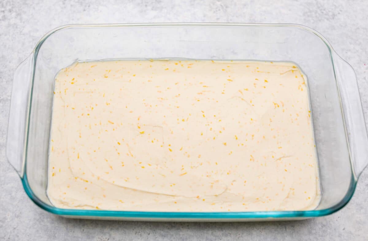 Orange creamsicle lush is sunshine in dessert form! With creamy orange layers, a buttery golden Oreo crust, and bright fresh citrus flavor, this easy no-bake dessert is a fun twist on my popular Lemon Lush that’s perfect for summer. Cream cheese mixture in the bottom of the 9x13 dish.