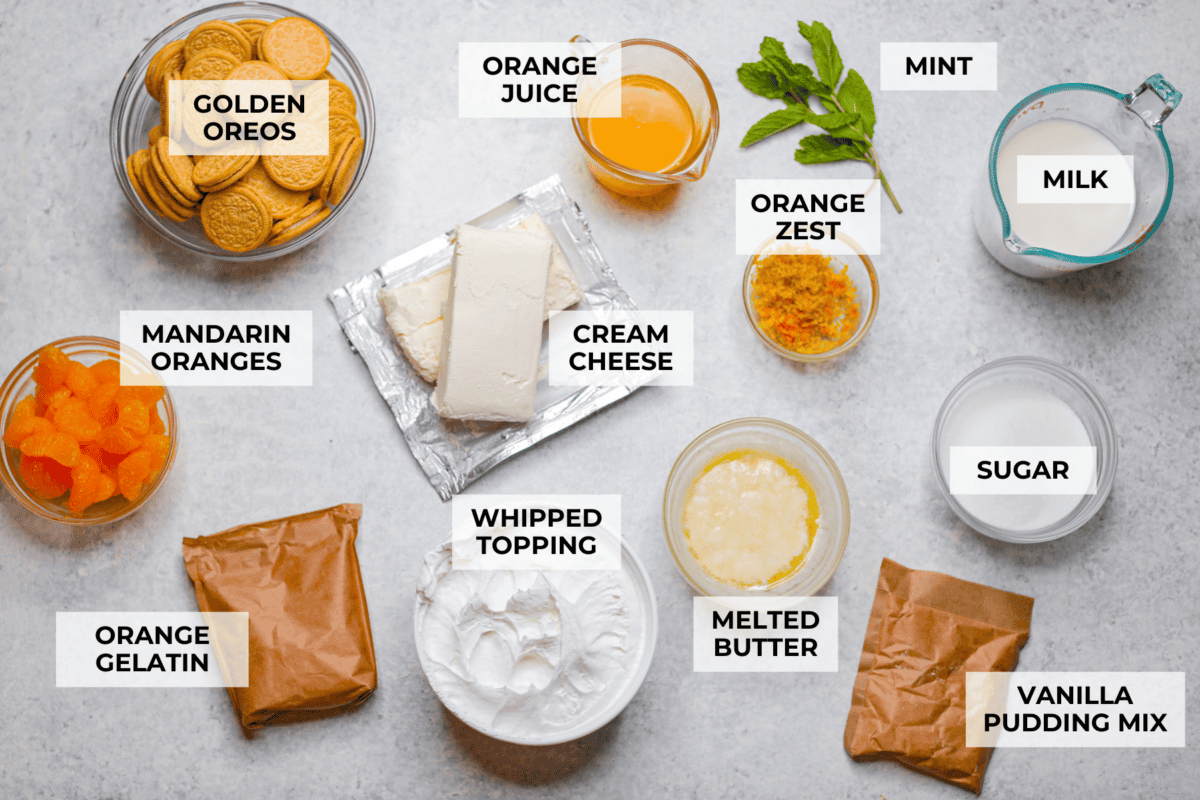 Orange creamsicle lush is sunshine in dessert form! With creamy orange layers, a buttery golden Oreo crust, and bright fresh citrus flavor, this easy no-bake dessert is a fun twist on my popular Lemon Lush that’s perfect for summer. Overhead shot of labeled orange creamsicle lush ingredients.