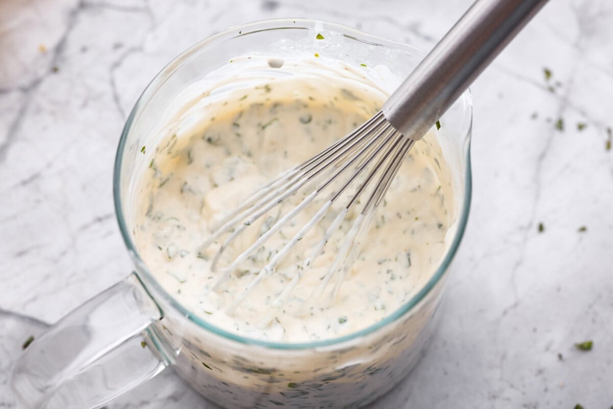 Ruth's Chris chopped salad is a steakhouse legend, and now you can make it at home for a fraction of the price. Crisp greens, smoky bacon, bold blue cheese, and a tangy lemon basil dressing come together in one showstopping bowl that tastes just like the real thing. All of the dressing ingredients in a container with a whisk.