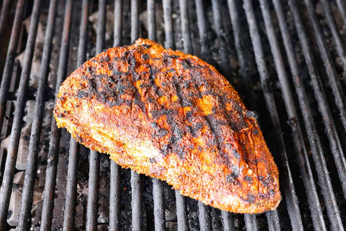 Santa Maria grilled tri-tip is juicy, smoky, and loaded with bold flavor from a delicious spice rub. Grilled until perfectly tender with a gorgeous crust, it’s an easy recipe that’s always a hit at cookouts and summer dinners. Santa Maria tri tip being seared on the grill.