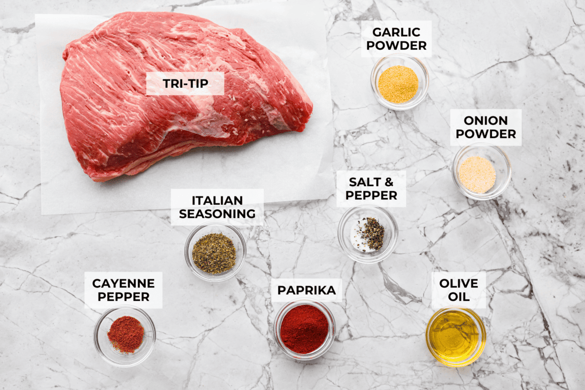 Santa Maria grilled tri-tip is juicy, smoky, and loaded with bold flavor from a delicious spice rub. Grilled until perfectly tender with a gorgeous crust, it’s an easy recipe that’s always a hit at cookouts and summer dinners. Overhead shot of labeled Santa Maria tri-tip ingredients.