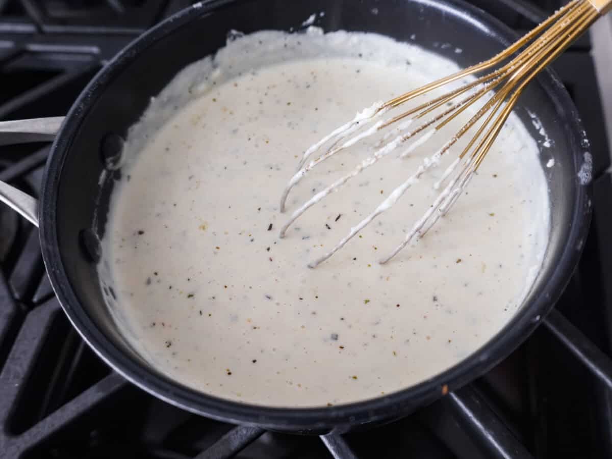 Someone whisking everything together in the pan. 