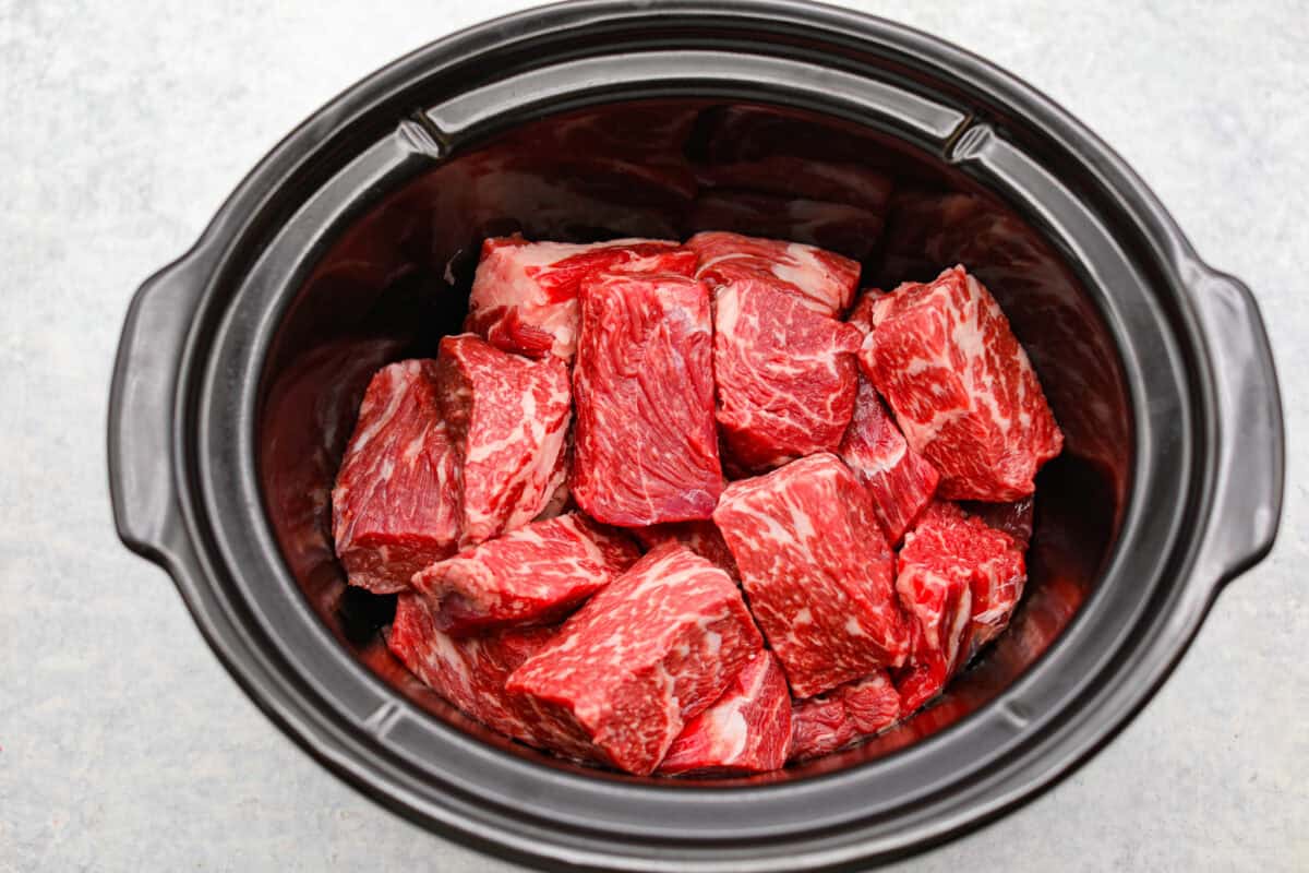 Cooks the chuck roast low and slow until it is tender, j Beef added to a slow cooker.