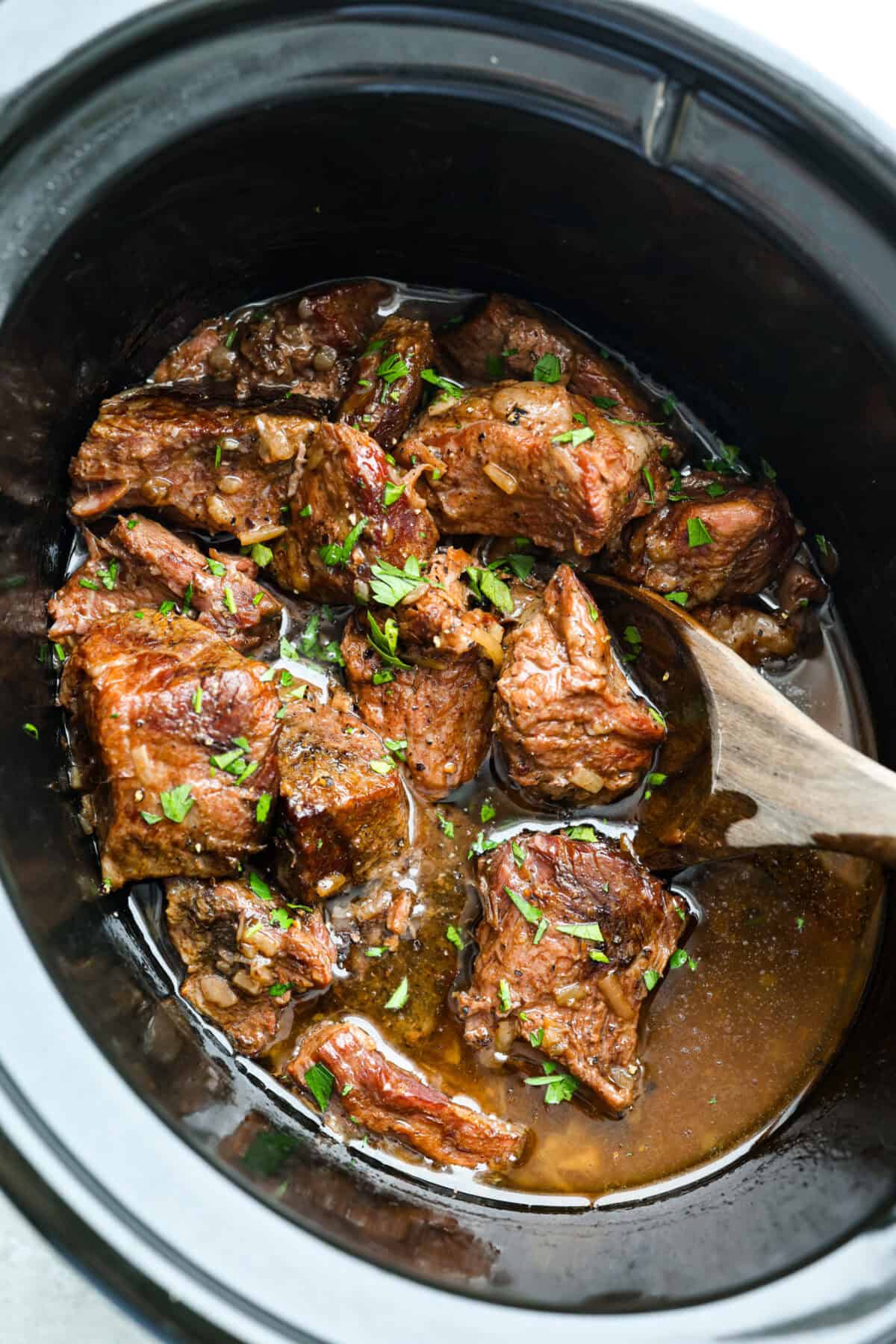 Cooks the chuck roast low and slow until it is tender, j Top down shot of cooked slow cooker 3 ingredient butter beef.