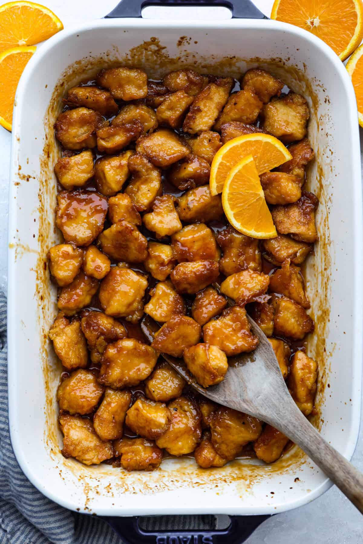 Top down shot of baked orange chicken in a 9x13 baking dish.