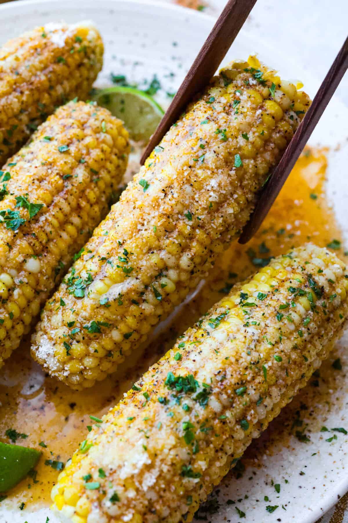 You already know I love a good corn recipe, and this Cajun corn on the cob is my new summer BBQ obsession. It takes sweet, juicy corn and gives it the buttery, spicy glow-up it deserves. Close up of cajun corn on the cob.